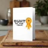 Cunt of the Year Greeting card on a wooden surface