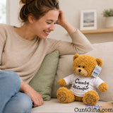 Cunty McCuntface soft toy teddy bear plush on sofa with woman smiling