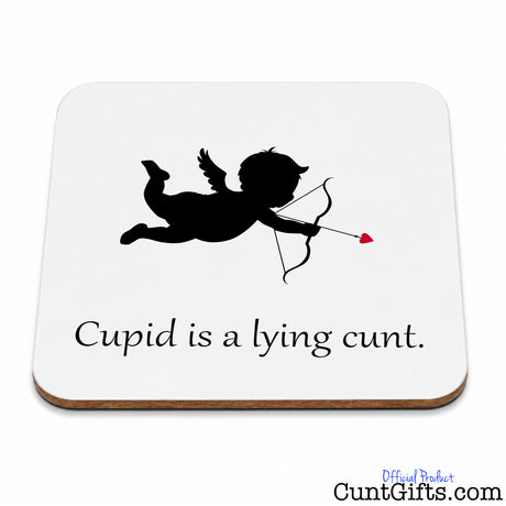 A square white coaster with rounded corners and a thin brown wood-look edge, featuring a black silhouette of Cupid with a bow and arrow and the text 'Cupid is a lying cunt.' on a white background.