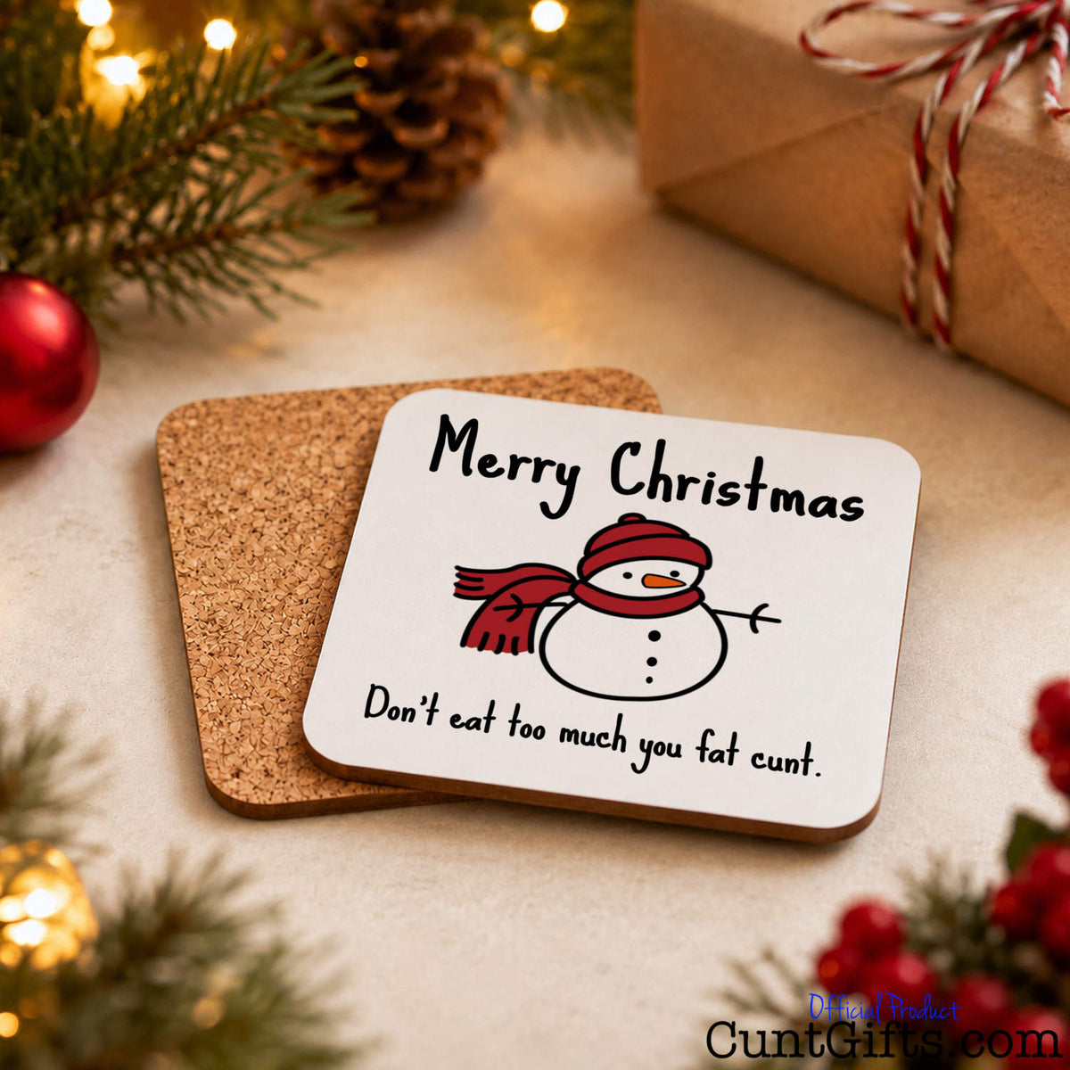 Don't Eat Too Much You Fat Cunt - Christmas drink coaster showing both sides and cork backing on festive table with gifts and baubles.