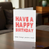 Happy Birthday, even though you're a cunt birthday card on a table in a living room setting