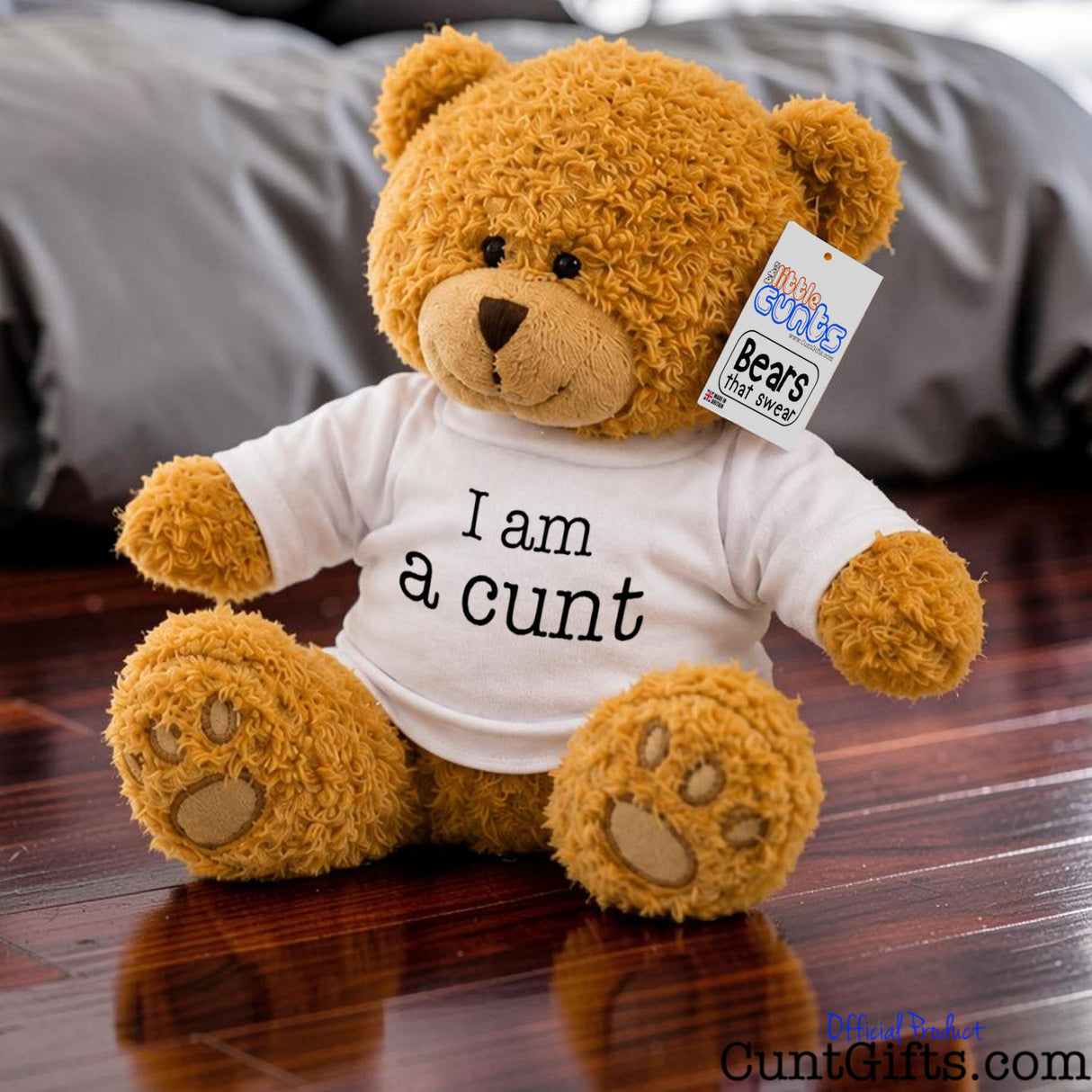 I am a cunt - Teddy Bear plush with golden brown fur on polished wooden floor in bedroom.