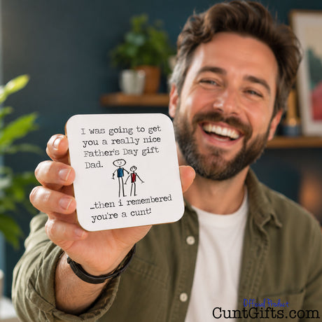 I remembered you're a cunt Dad -  Father's Day Drink Coaster held by laughing bearded dad in green shirt by plant.