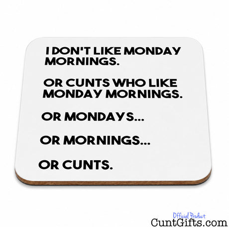 A square whitedrinks coaster with rounded corners and a thin brown edge, printed with black text that reads, 'I DON'T LIKE MONDAY MORNINGS. OR CUNTS WHO LIKE MONDAY MORNINGS.