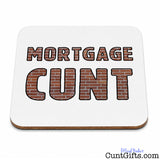 A square white coaster with rounded corners featuring the words 'MORTGAGE CUNT' in large block letters filled with a brown brick pattern and black outlines. The coaster is shown on a clean white background with a small 'Official Product CuntGifts.