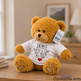 You're a cunt but you're my cunt - Personalised Teddy Bear on bedroom sideboard next to books with lamp and wall picture in background.
