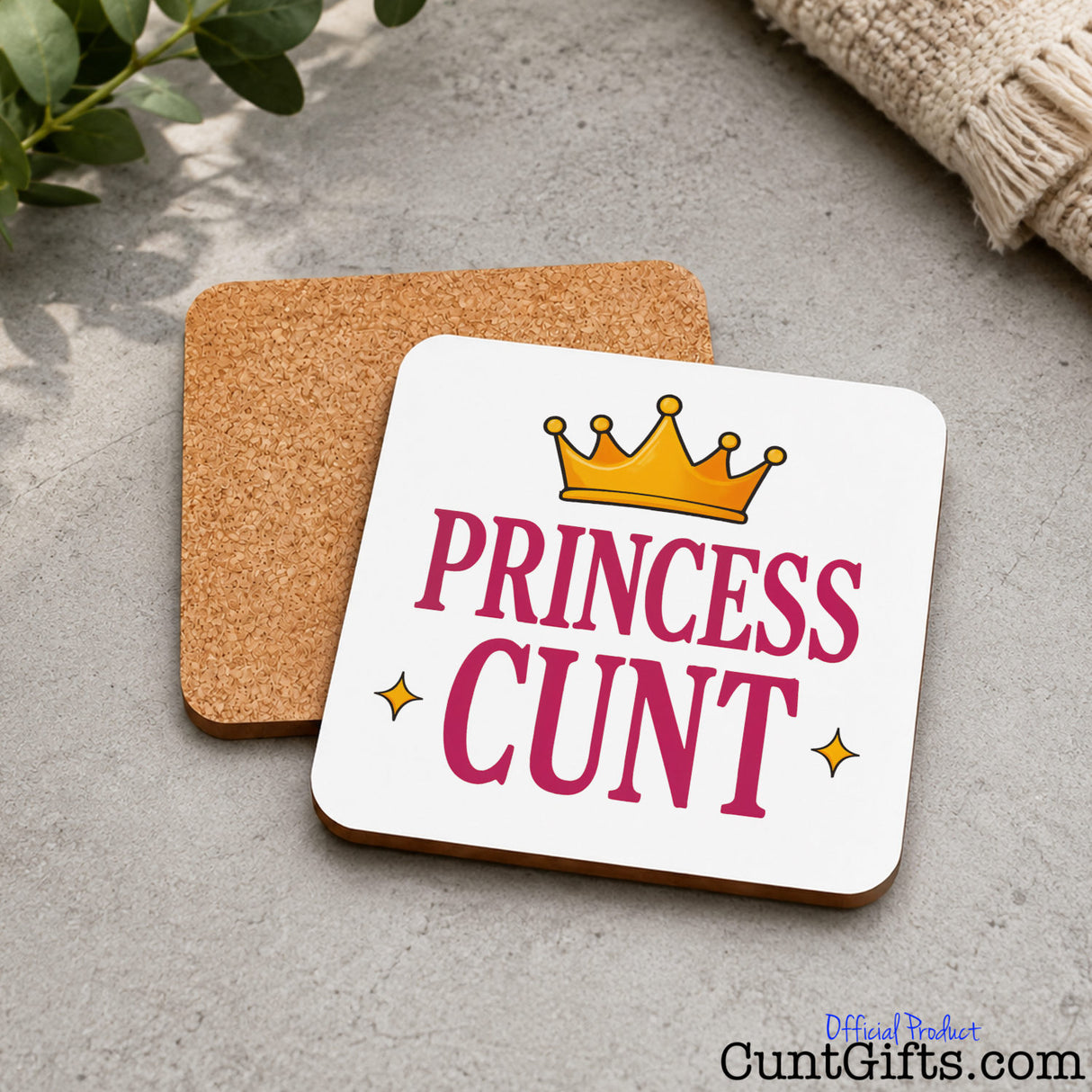 Princess Cunt Drink Coaster on marble with cloth and leaves