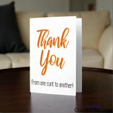 Thank You From One Cunt To Another Greetings Card on the coffee table by a sofa.