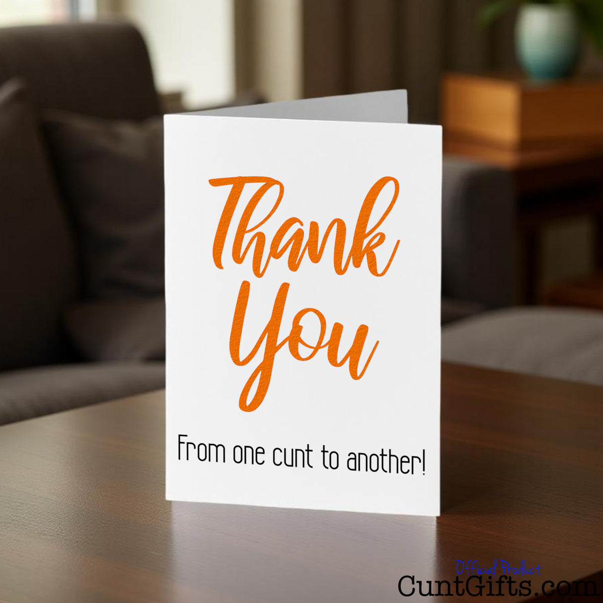 Thank You From One Cunt To Another Greetings Card on wooden coffee table in lounge.