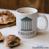 Uni Cunt Mug on table with pastries