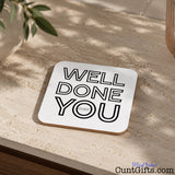 Well Done You Cunt - Drinks coaster  on stone worktop next to plant.