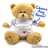 A plush teddy bear sitting against a white background, wearing a white T-shirt with printed black text and a small red heart. A hangtag on the ear reads 'Custom Cuddly Bears' and there is blue handwritten text saying 'Choose Any Name!' with an arrow pointing to the shirt.