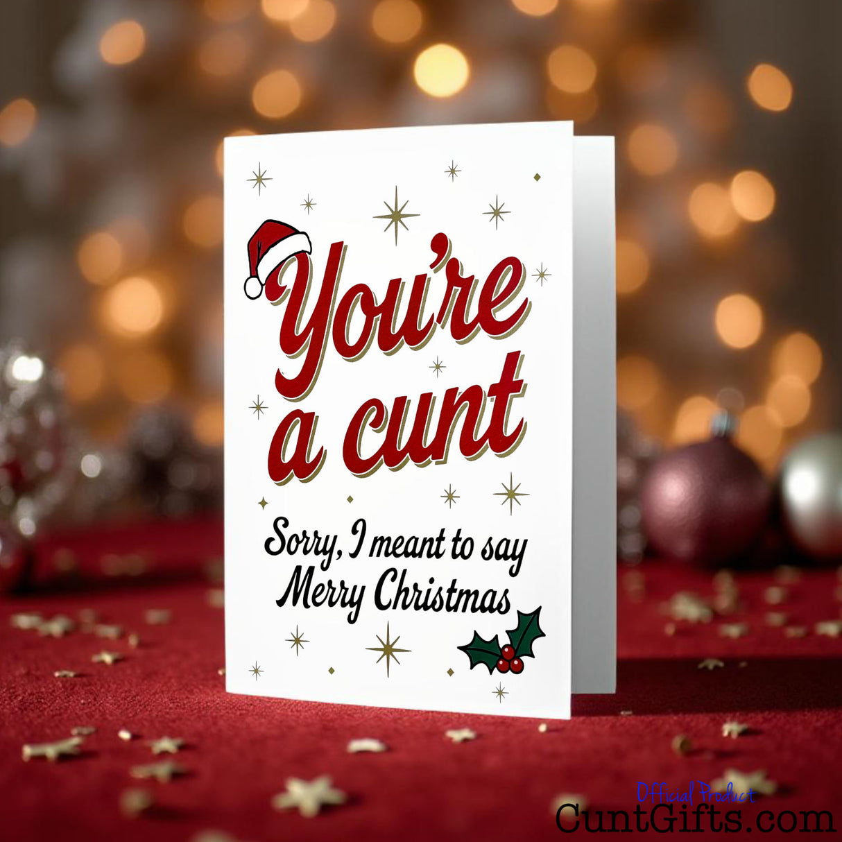 "You’re a cunt. Sorry, I meant to say Merry Christmas"  Card on red velvet with baubles and fairy lights.