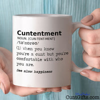 Cuntentment - Mug held by woman in light blue blouse