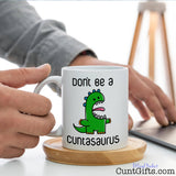 Don't be a Cuntasaurus - Mug on desk working from home
