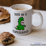 Don't be a Cuntasaurus - Mug with coffee and pastries