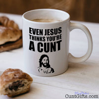 Even Jesus Thinks You're a Cunt - Mug with coffee and pastries