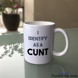 I Identify as a cunt mug on glass table
