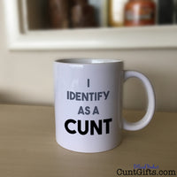 I Identify as a cunt mug on sideboard