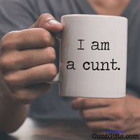 I am a cunt - Mug being held by man in grey t-shirt