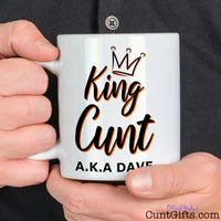 King Cunt Mug held by man in black shirt