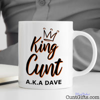 King Cunt Mug on desk with man writing