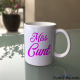Miss Cunt Mug on Glass Table