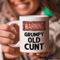 Warning - Grumpy Old Cunt - Mug held by smiling woman