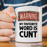 Warning my favourite word is cunt - Mug on table held by woman with striped tee